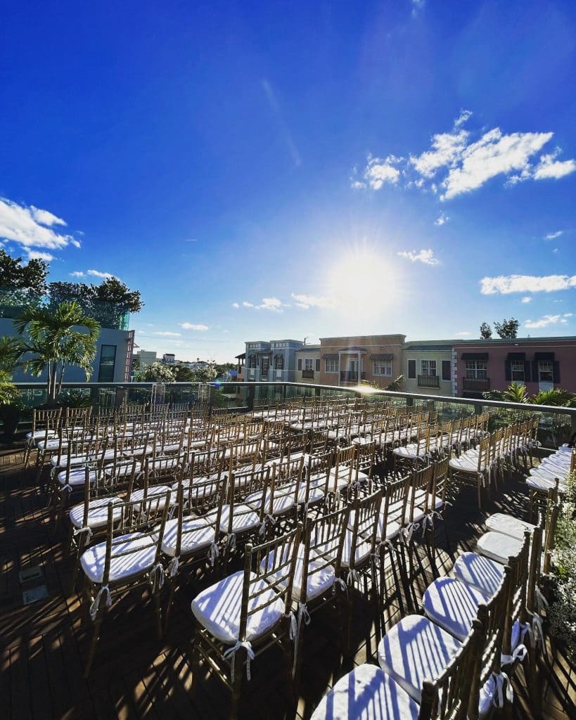 Outdoor ceremony location, rows of chairs set with a center aisle, sun shining with blue skies, Orlando, FL
