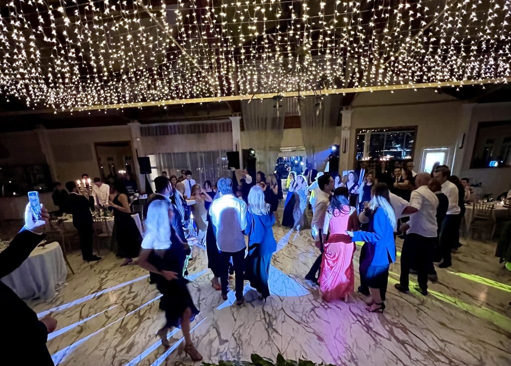 Wide arial shot of the dance floor with colorful lights, guests having a great time, Diamond Dj Events, Orlando, FL