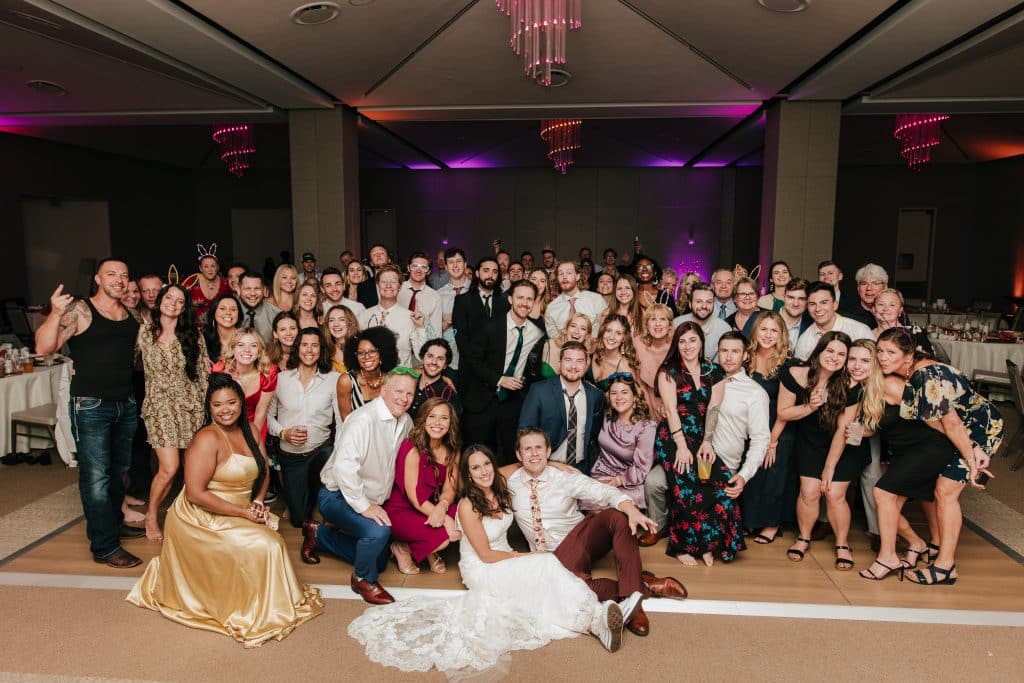large group photo at the reception, bride and groom down in the front, Orlando, FL