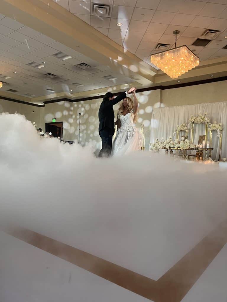 Bride and Groom dance through fog on the dance floor, Orlando, FL