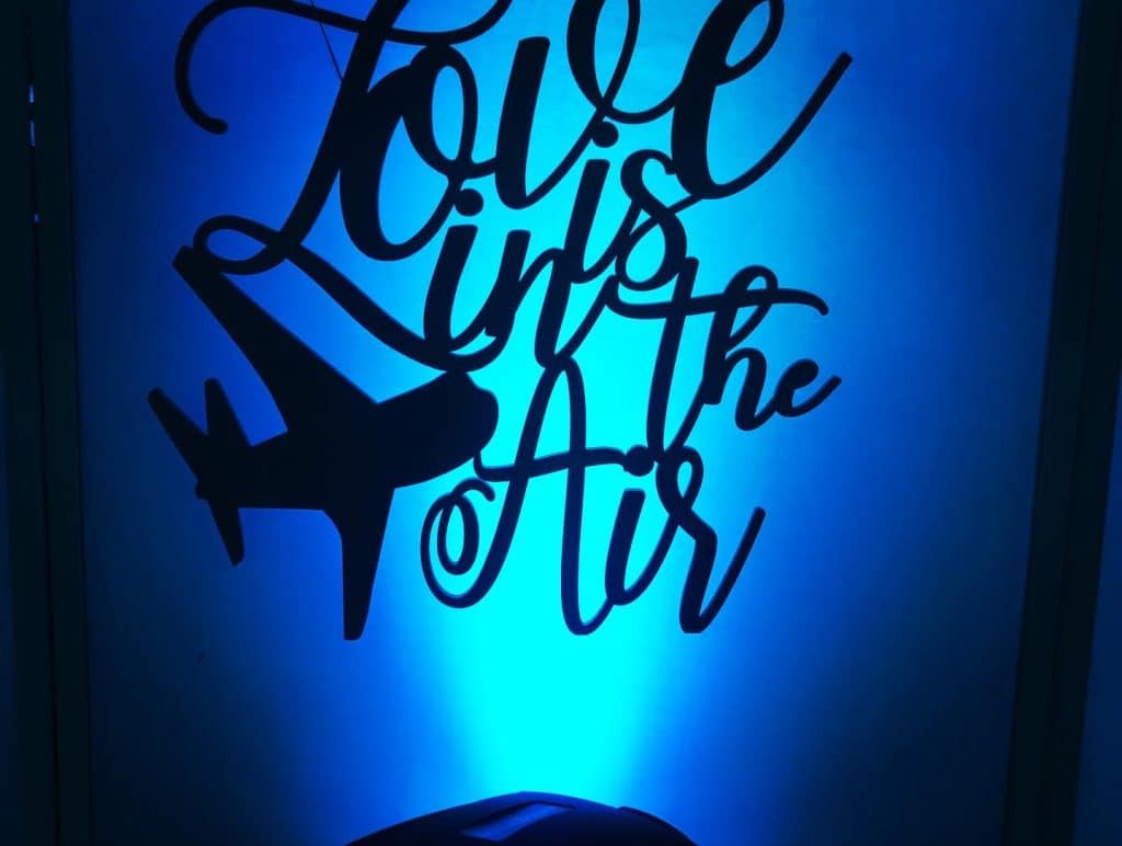 Love is in the Air sign in black on a blue uplighting background, Orlando, FL