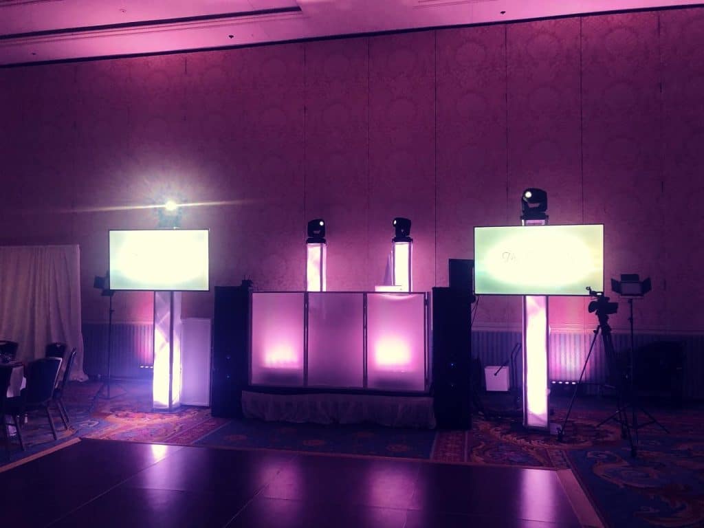 DJ booth set up with soft purple lighting and two tv screens set up on either side of the booth, Dash of Class Platinum, Orlando, FL