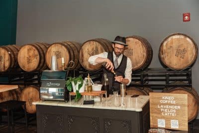 set up of the mobile espresso bar for Kineo Coffee, large barrels behind, Orlando, FL