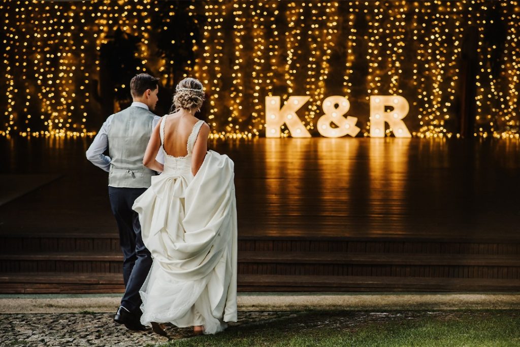 Couple heading to the dance floor with K&R light up letters illuminating the floor, Orlando Marquee & Decor, Signs that light up, individual letters or words spelled out, Central FL