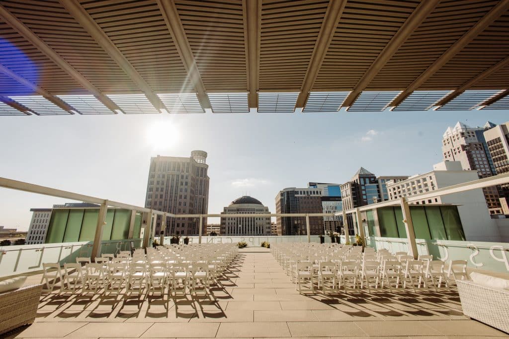 wedding ceremony set up on roof of building outside looking at city skyline