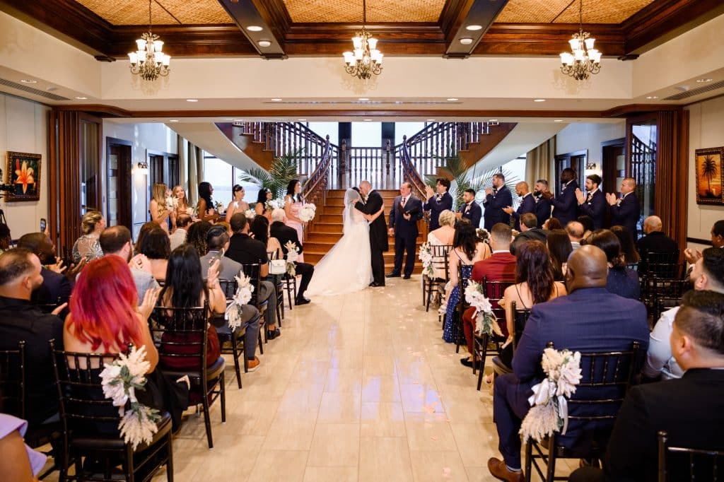 wedding ceremony with bride and groom in front of staircase