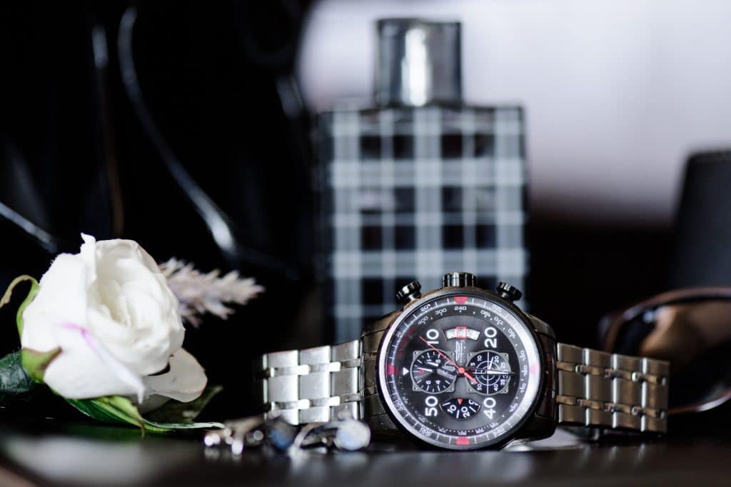 watch and men's perfume pictures with rose next to it