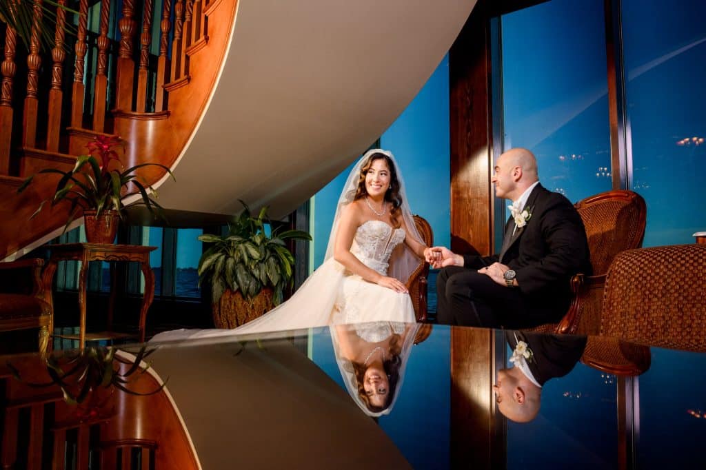 bride and groom sit down looking in the distance for wedding portrait
