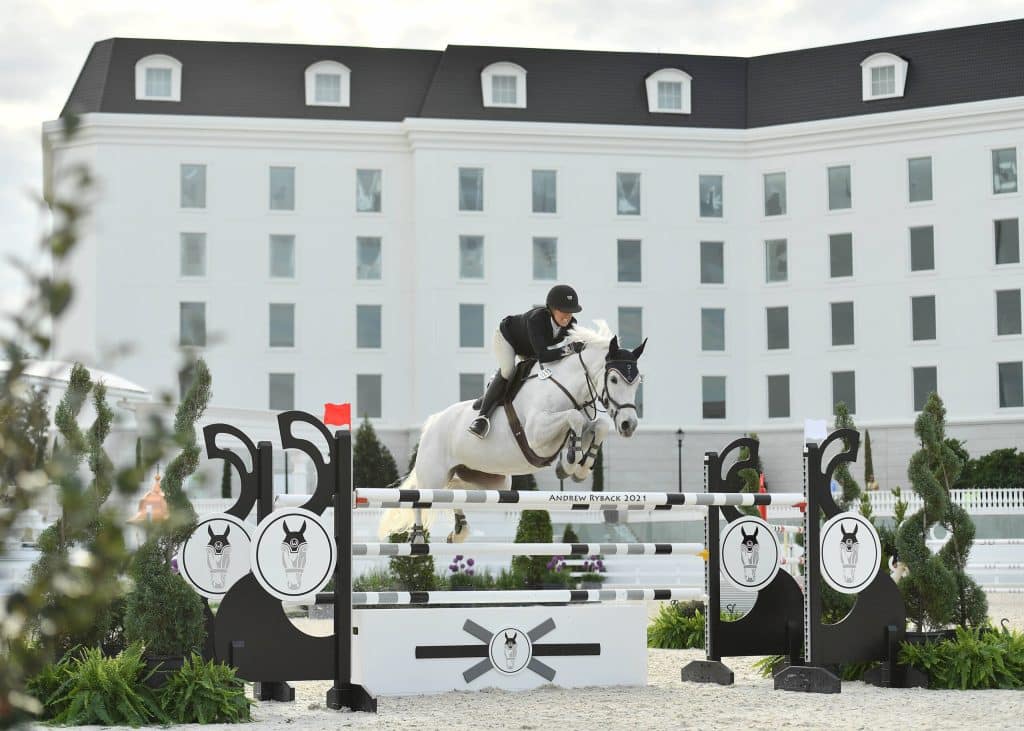 rider and horse jumping at a competition, world equestrian center, orlando, fl