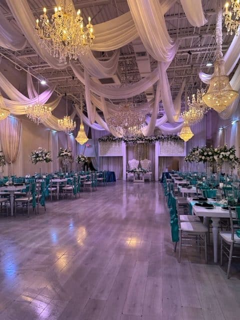 indoor venue, purple and yellow lighting, tables and chairs set for a reception, One Night Only, Orlando, FL