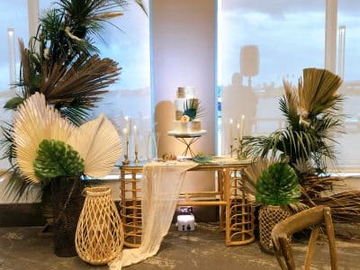 wedding cake displayed by the window, tropical vibe, palm frons, wicker table and furnishings, Central, FL