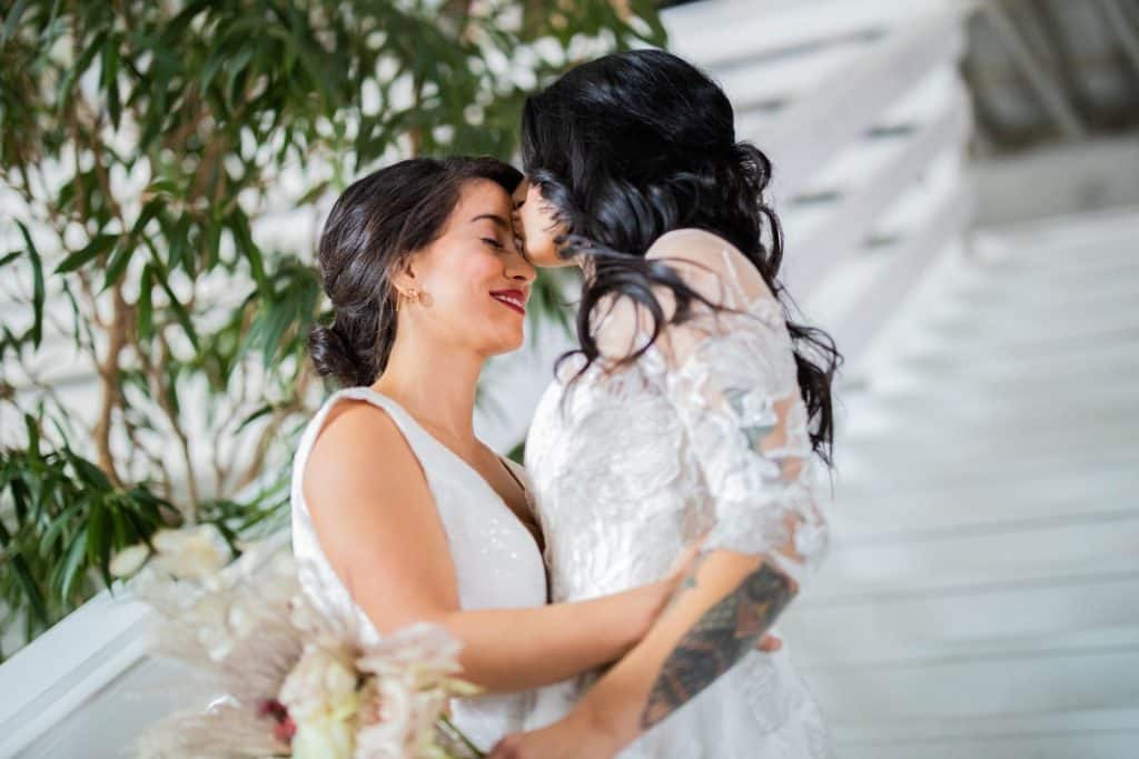 two brides, embracing on their wedding day, I Now Pronounce You, Orlando, FL
