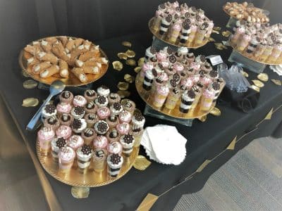 dessert shooters and cannolis, displayed on a table with a black tablecloth, central, fl