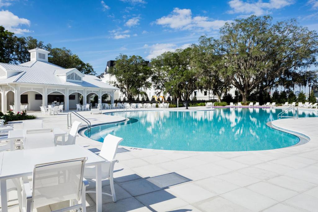 Pool and patio at the world equestrian center, white tables and chairs, beautiful scenery, clear skies, orlando, FL