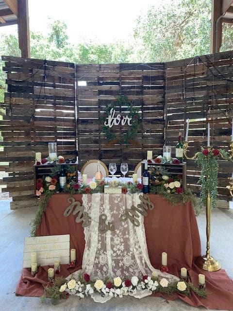 head table at the outdoor venue, candles and flowers, mr & mrs, white lace, wooden screen behind the table, brown tablecloth, Orlando, FL