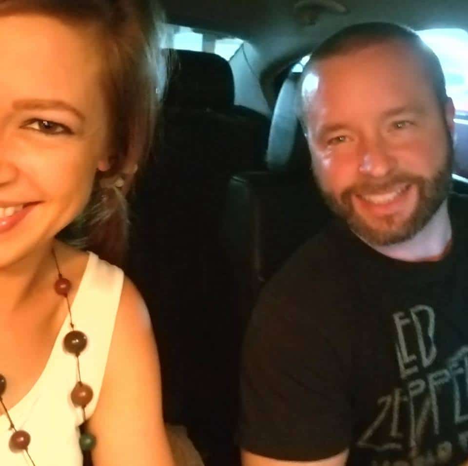 man and woman take selfie in car