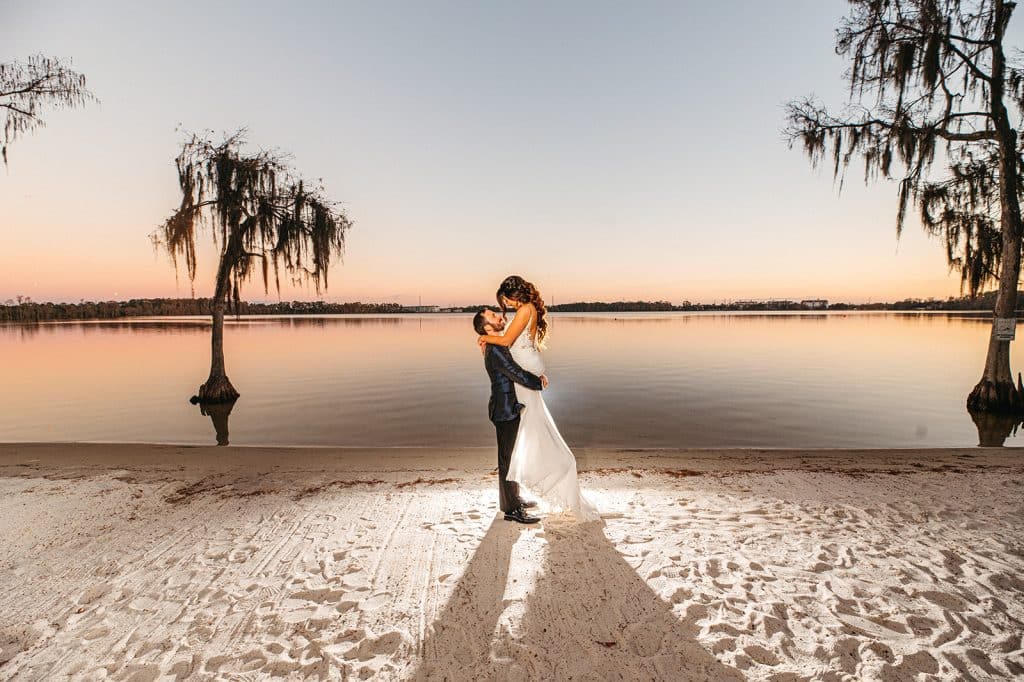 bride and groom on the beach at sunset, palm trees, central Fl, paradise cove