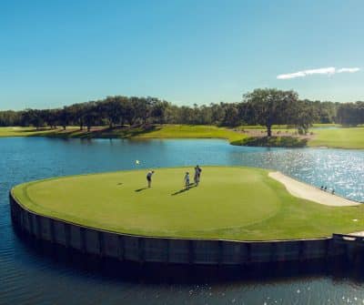 golf course, tee surrounded by water, blue skies, Orlando, FL