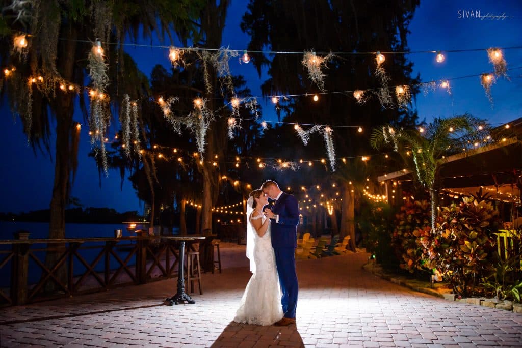 bride and groom dancing outdoors, lantern lights hanging above, paradise cove, central fl