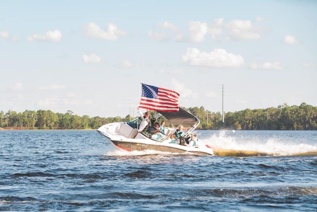 american flag, boat on the open water, clear sky, Central FL