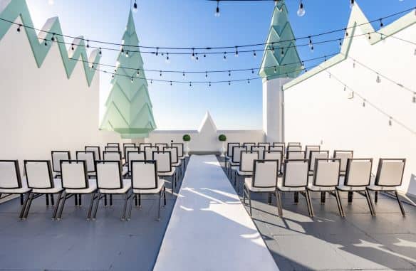 outdoor ceremony set up, large white walls, white carpet runner, hanging lights, Castle Hotel, Central FL