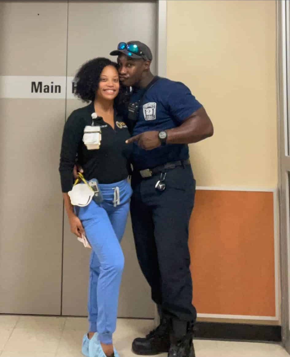 woman nurse stands next to man as firefighter in front of elevator