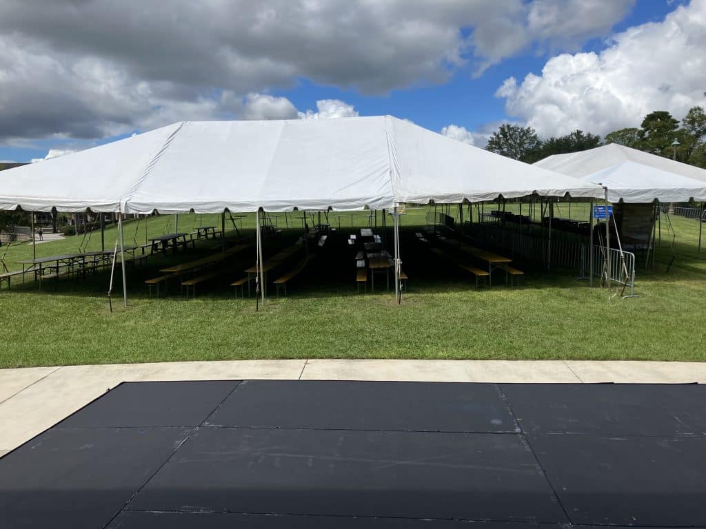 large white tents set out on the large lawn, clouds overhead, Central FL