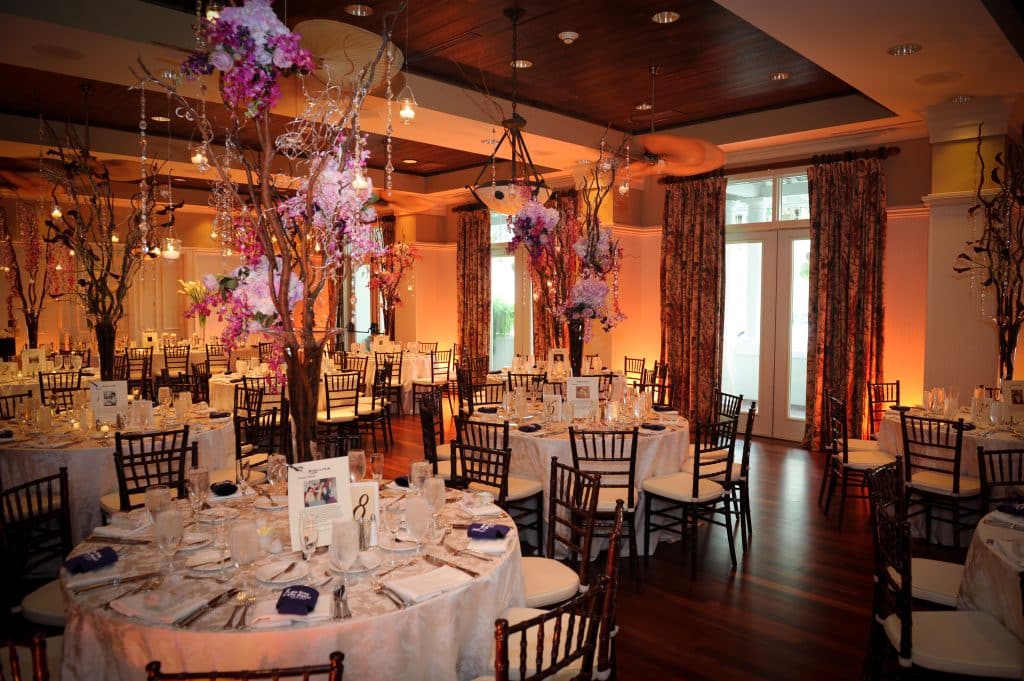 indoor wedding reception, pink and purple flower centerpieces, towering over each table, Orlando, FL