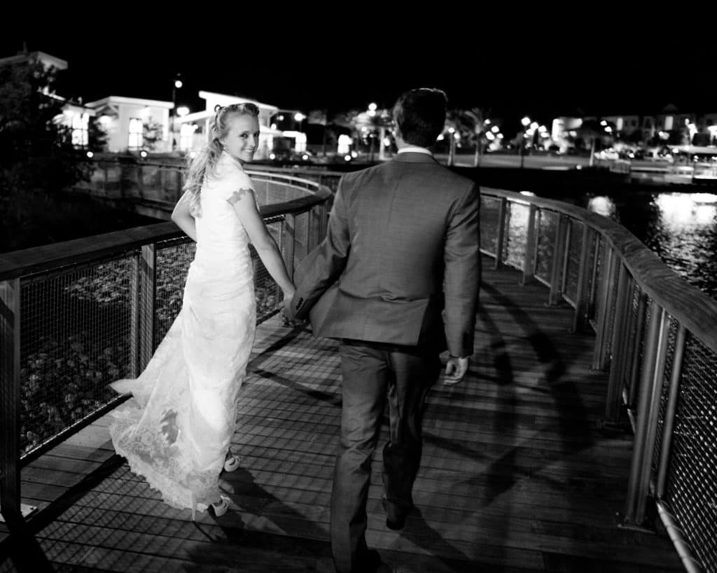 bride and groom walking on the bridge to the amphitheatre, Oviedo Amphitheatre and Cultural Center, Central FL