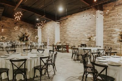 Wedding reception room with white linens and rustic flowers