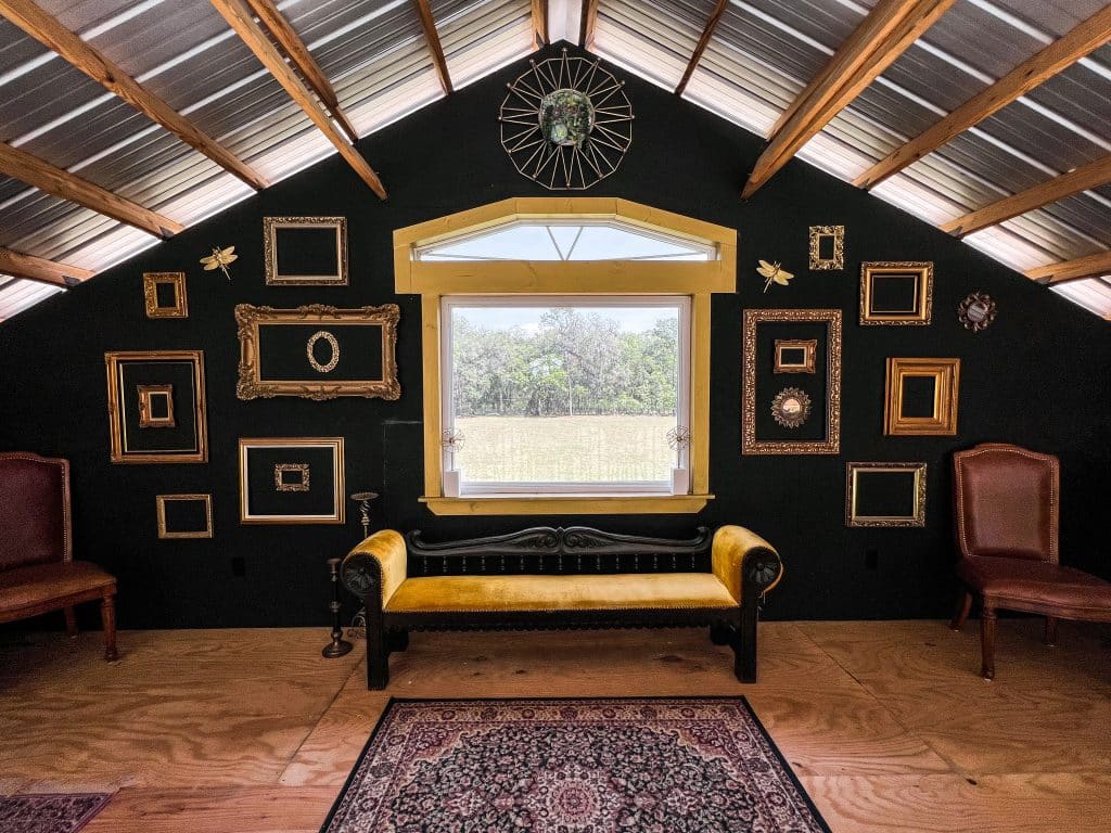 sitting room, gold and black theme, frames on the back wall, Orlando, FL