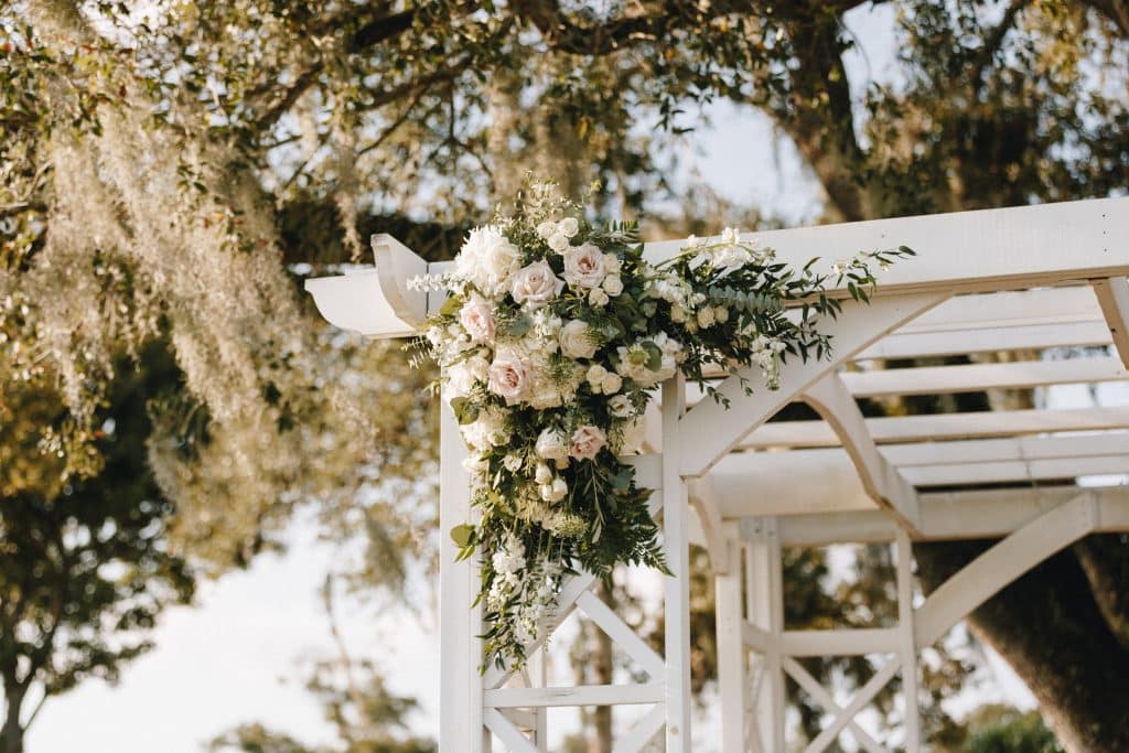 close up of the white pergola, with white flower display on the top left corner, Tuscawilla Country Club, Orlando, FL