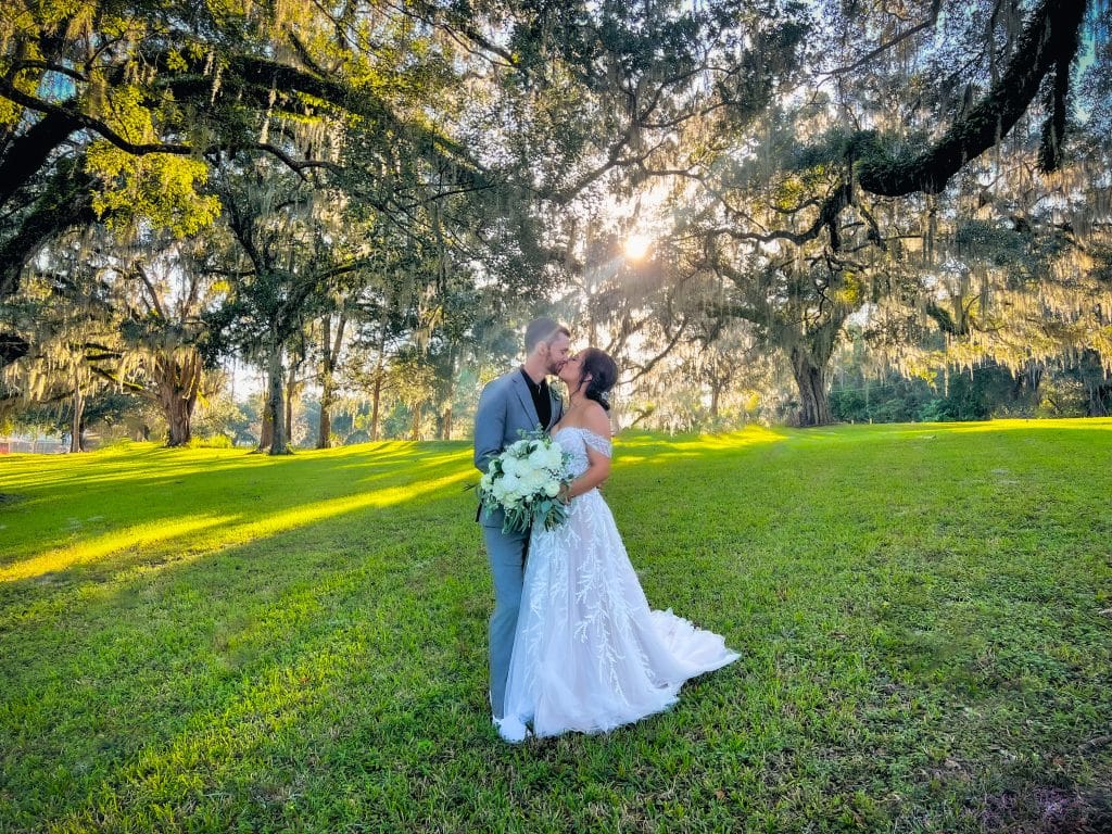 bride and groom embracing in a field, Orlando, FL