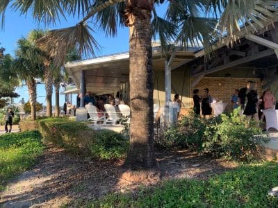 porch area, reception set up with high tops and white adirondack chairs, palm trees, Central FL