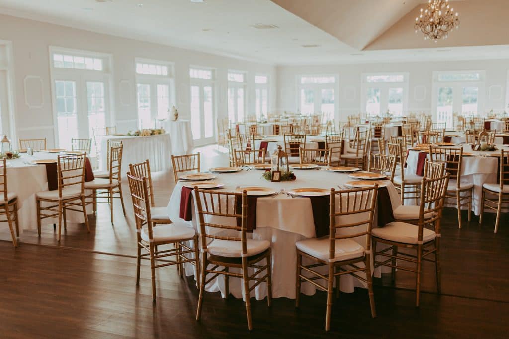reception set up, round tables, white tablecloths, black napkins, large windows around the room, Orlando, FL