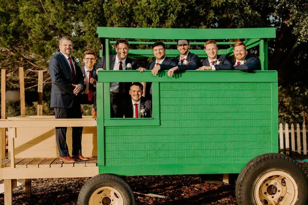 members of the wedding party on a wagon decorated as a john deere tractor, Orlando, FL