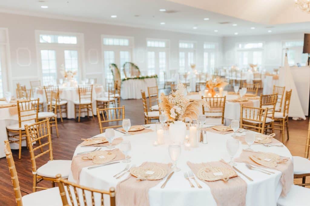 round tables with white tablecloths, tan napkins, gold backed chairs with white cushions, Orlando, FL