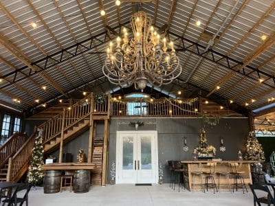 venue pavilion, large wooden staircase on the left side, tables and chairs, wood barrels, Orlando, FL