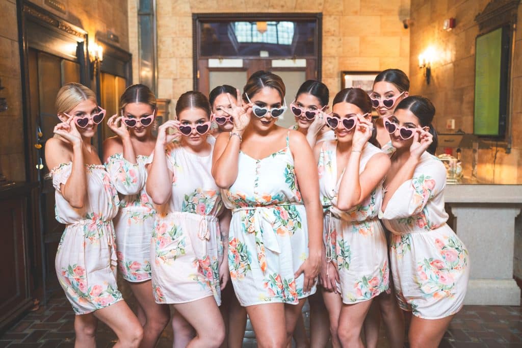 bride with her attendants, wearing pink sunglasses and floral jumpers, Central FL