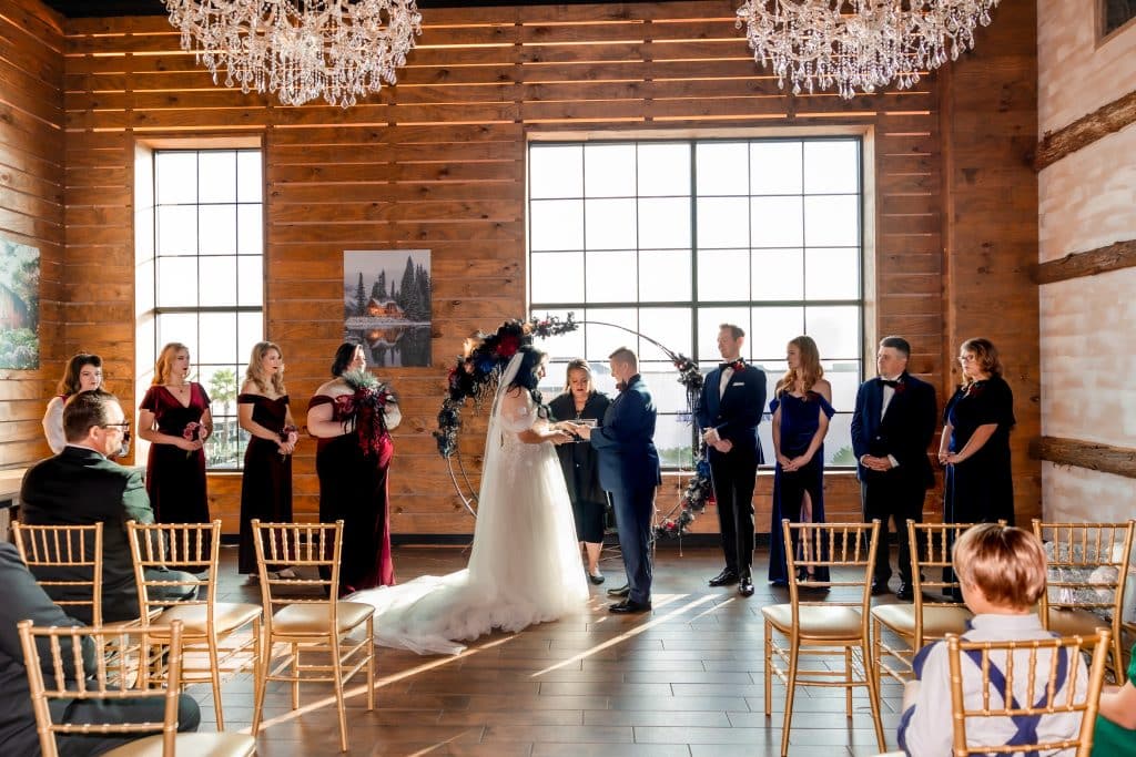 wedding ceremony, bride and groom with wedding party standing on both sides, guests watching from their chairs, Orlando, FL