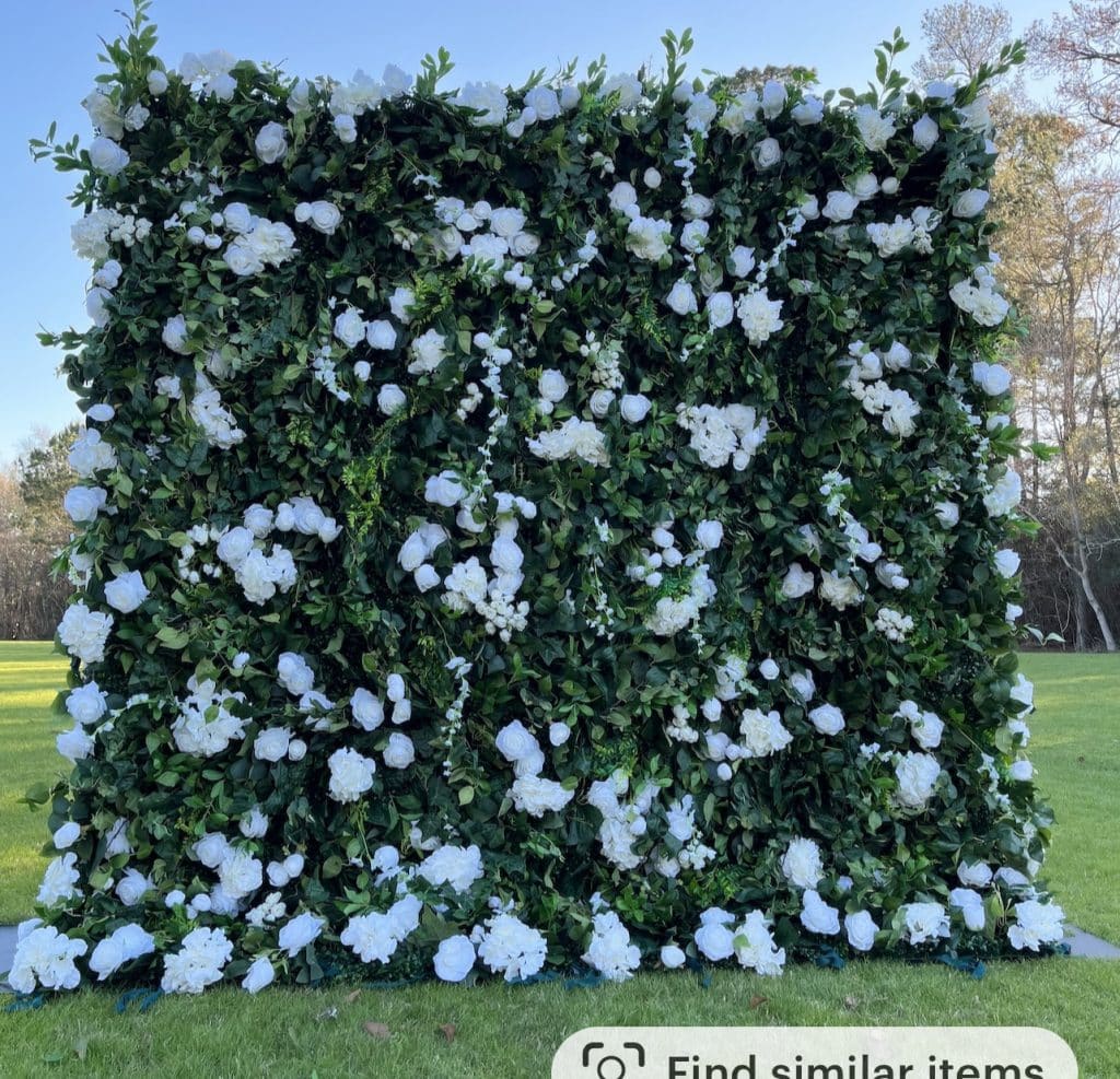 Wall of greenery and white flowers dispersed throughout, Petal Party Rentals, Orlando, FL