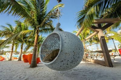 large hanging chair at the beach, sand, palm trees, Evermore Orlando Resort