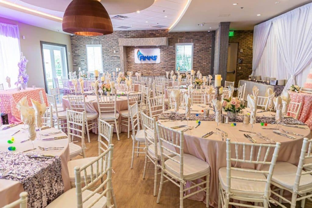reception set up, white chairs, light pink tablecloths, flower centerpieces, Orlando, FL