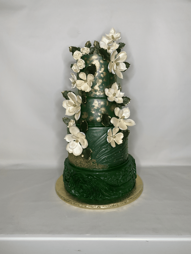 dark green four tiered cake, large white flowers on both sides, gold platter, gold spray embellishments, Orlando, FL