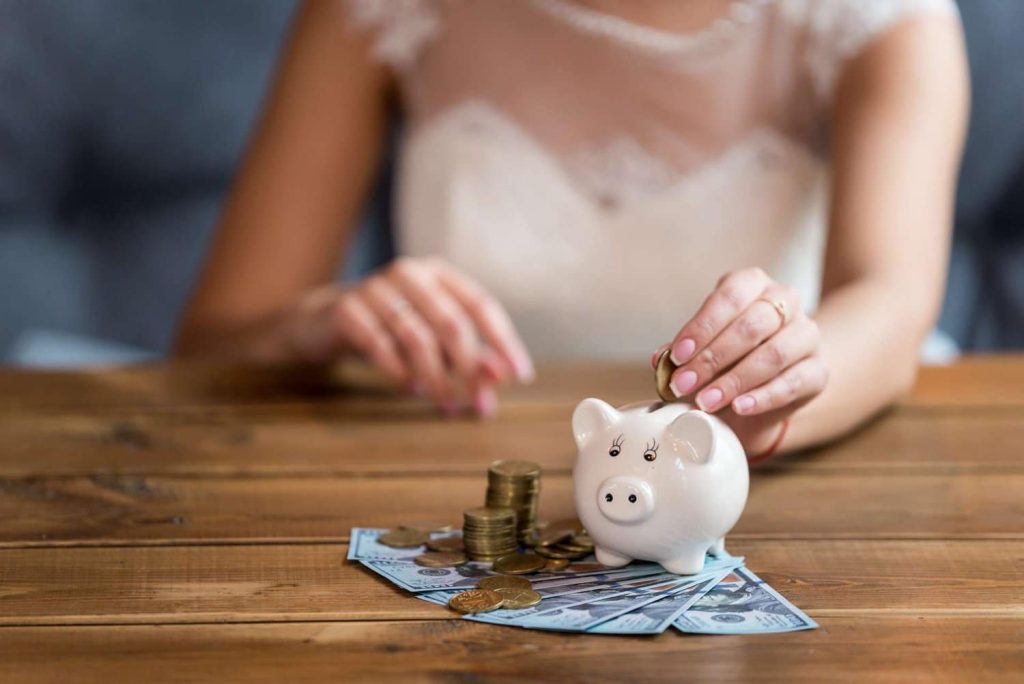 bride_putting_money_in_piggy_bank (1)