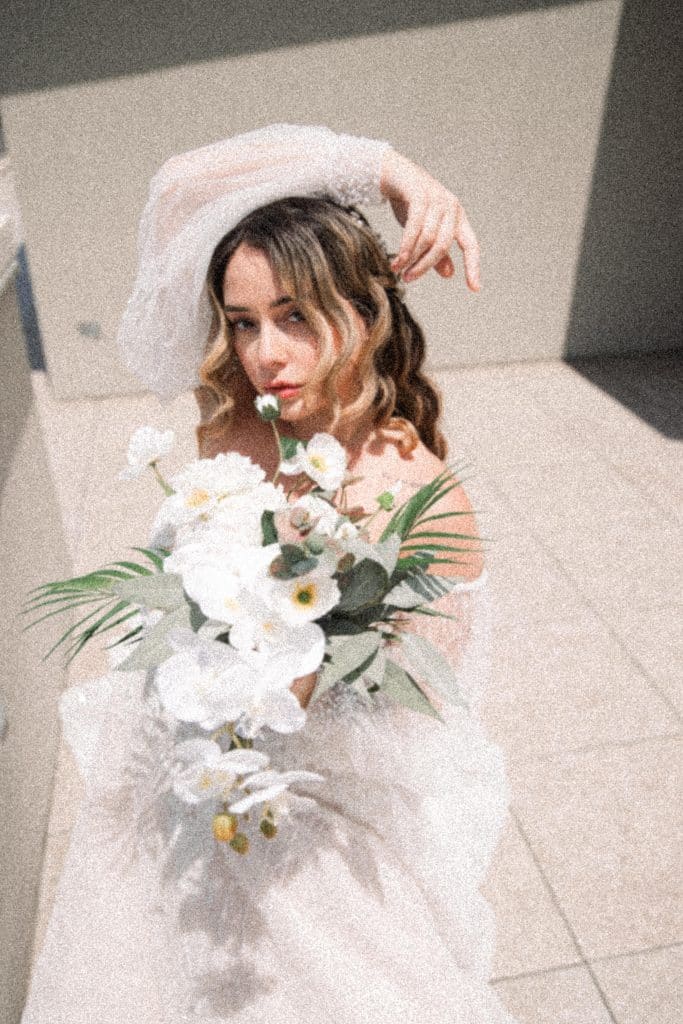 bride posing for the camera, white floral bouquet, Orlando, FL