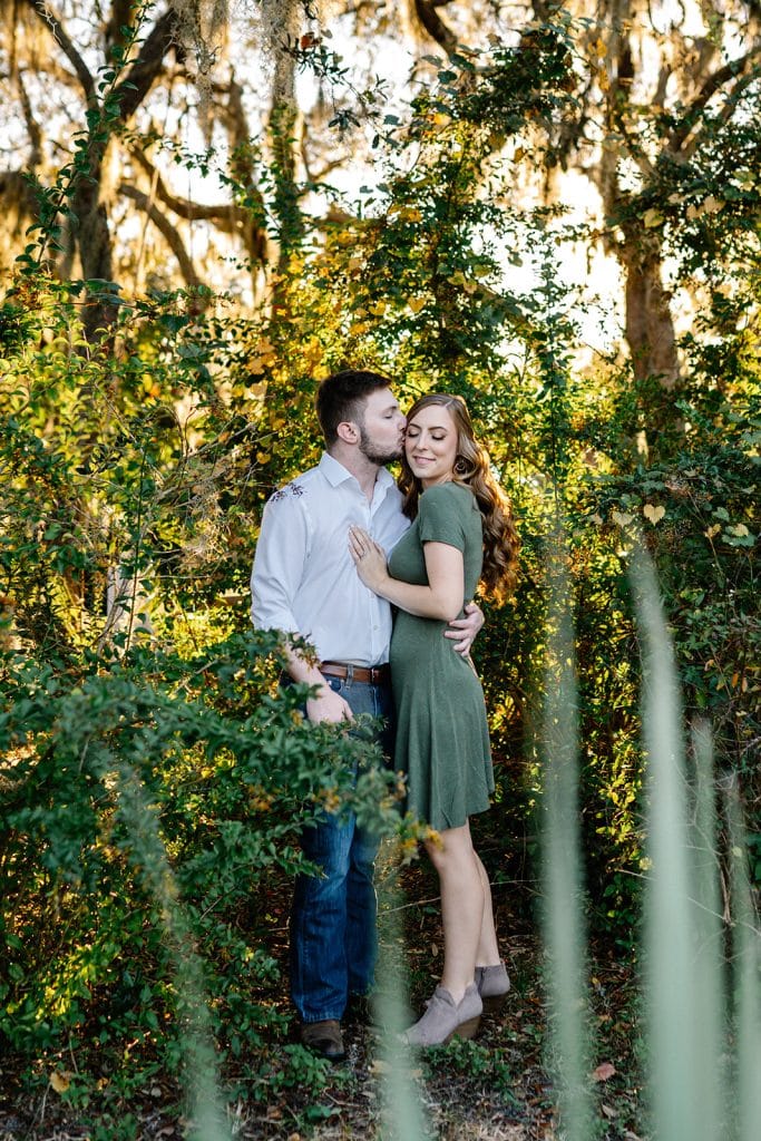 man and woman engagement pictures outside at park