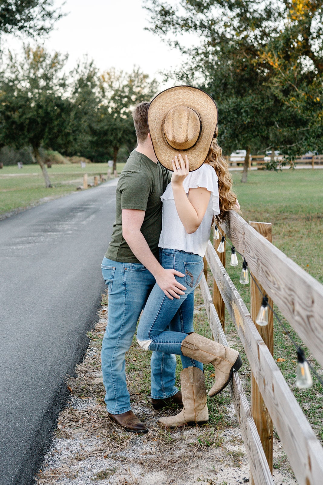 man and woman engagement pictures outside at park