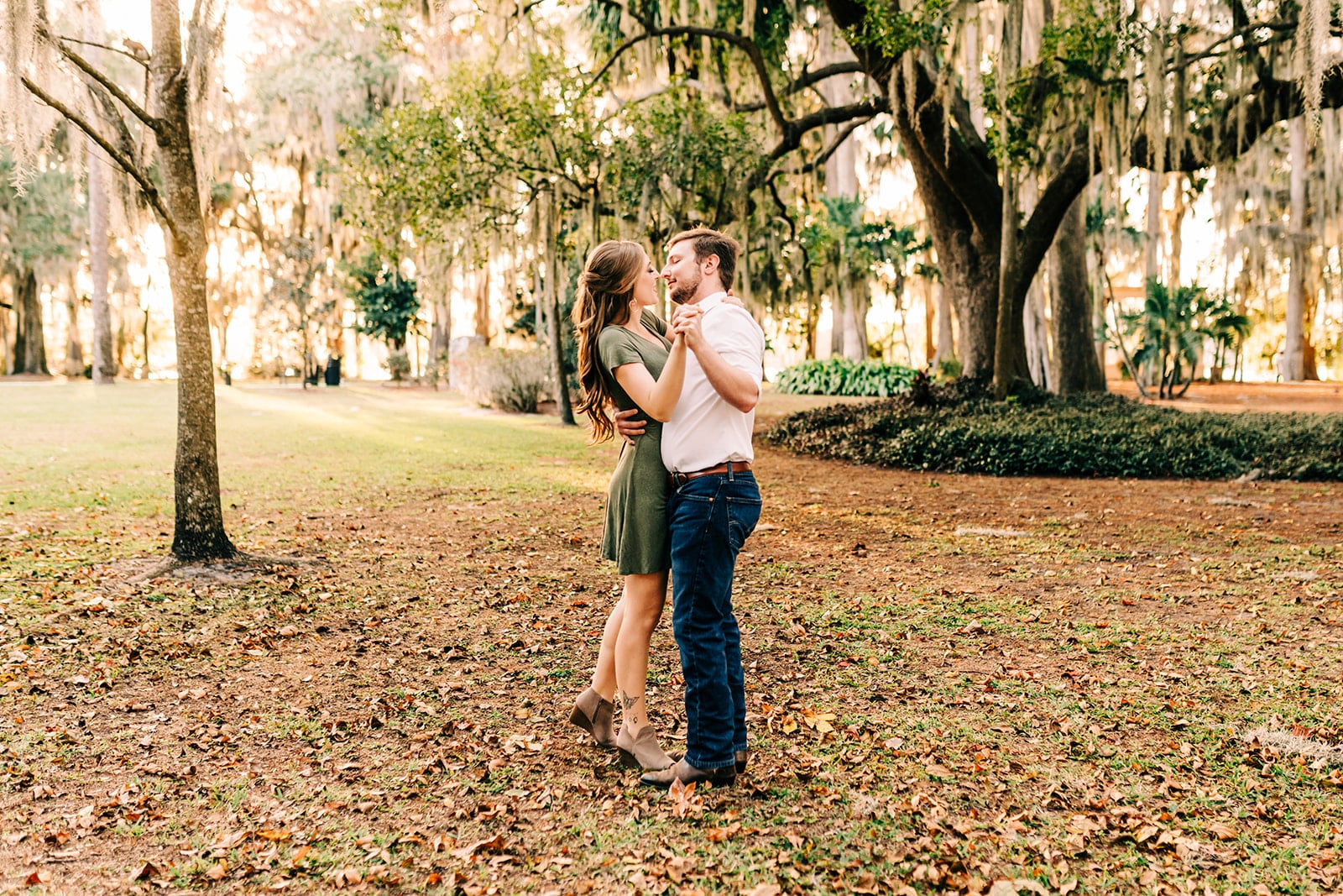 man and woman engagement pictures outside at park