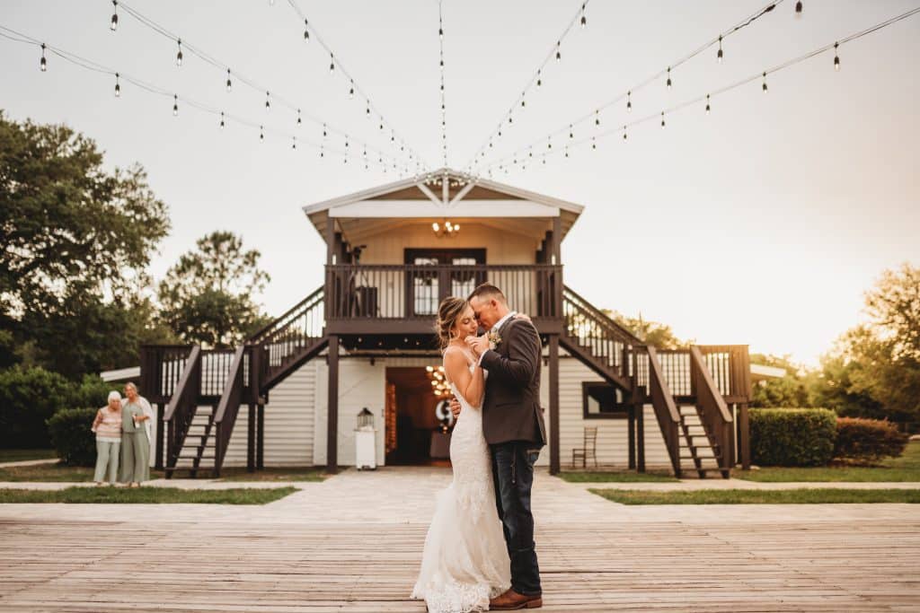 Bride and groom dancing, twinkle lights hanging from above, The Enchanting Barn, Orlando, FL